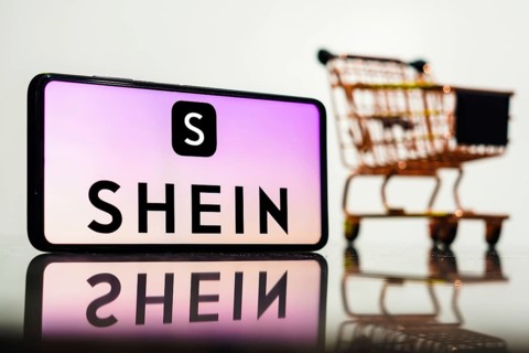 In this photo illustration, the Shein logo seen displayed on a smartphone along with a shopping