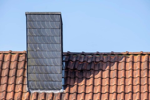 Chimney on a clay tile roof