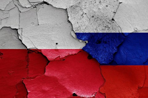Flags of Poland and Russia painted on cracked wall