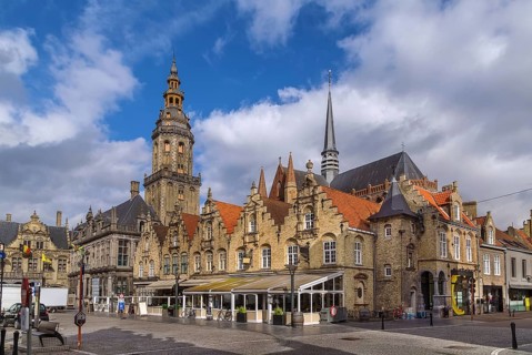 View of main market square with belfry and church in Veurne, Belgium, Europe