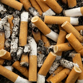 Cigarettes texture, busy ashtray square still shot