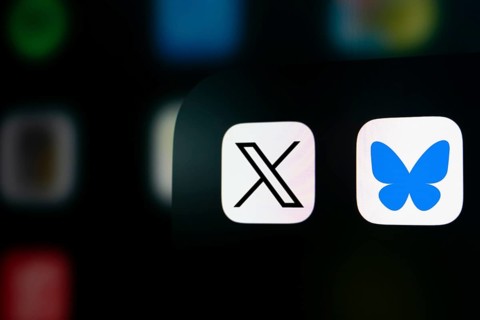 A close up of an iPhone screen displaying the X (twitter) app icon and the Bluesky app icon.