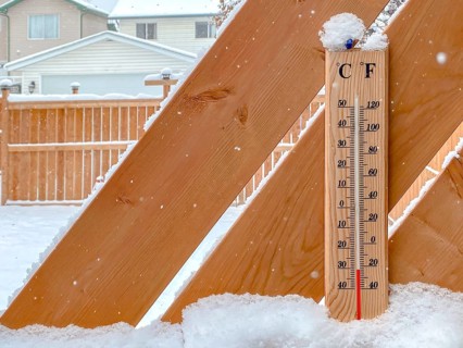 A Thermometer on a snow fall with a cold temperature