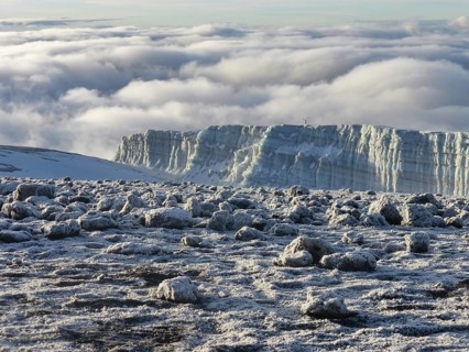 glacier remains and snow covered summit of Mount Kilimanjaro in Tanzania just after sunrise