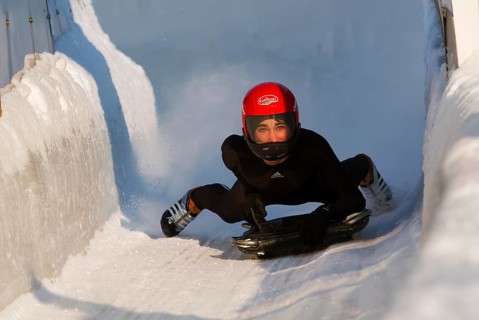 Person riding a skeleton sled at the Innsbruck bobsleigh track, Igls Olympic Bobsled Run, Igls,