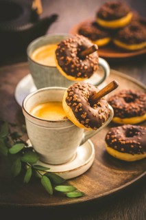 Two cups of Caffe Americano with small chocolate donuts