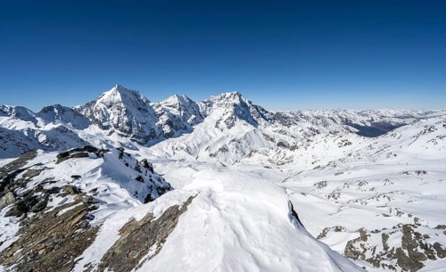 Mountain panorama with snow-covered mountain landscape in winter, view of mountain peaks