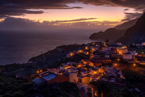 The village of Agulo shortly in front of sunrise. Houses and streets are still illuminated. View of