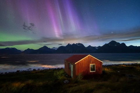 Northern Lights over a hut at the Lyngenfjord, Lyngen Alps, Lyngen, Troms og Finnmark, Norway,