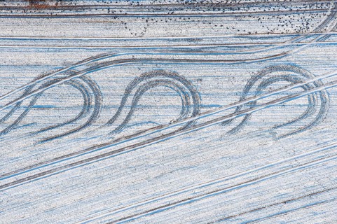 Aerial view tractor tracks on a snowy field, winter, curve, turn, agriculture, Lower Saxony,