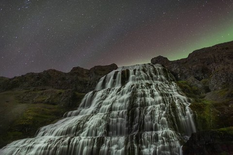 Northern Lights or Aurora Borealis over Dynjandifoss or Fjallfoss, the largest waterfall in the