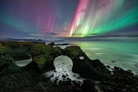 Northern lights over rock structure, coast near Arnarstapi, Snäfellsnes peninsula, Snæfellsnes,