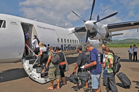 Propeller aircraft, prop jet Fokker 50, former Riau Airlines, passengers at the airport in Labuan