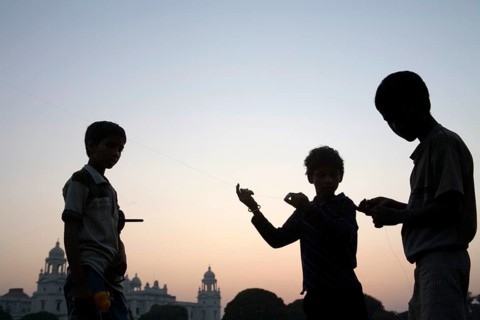 Children flying kite near at Victoria memorial impressive reminder of British Raj built between
