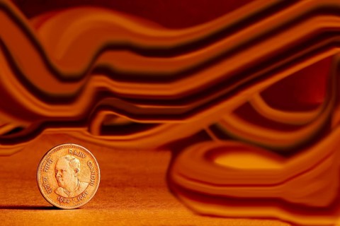 One single Indian currency one rupees coin and artistic background backside embossed Rajiv Gandhi