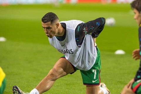 Football match, Cristiano RONALDO CR7 Portugal kneeling during pre-match warm-up with right leg and