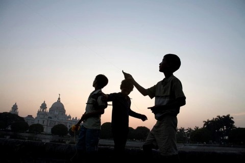 Children flying kite near at Victoria memorial impressive reminder of British Raj built between