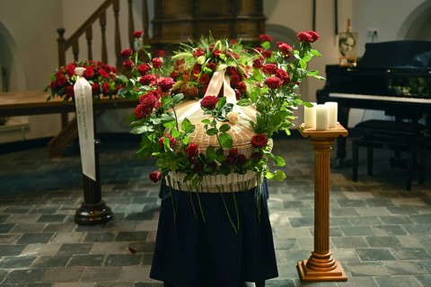 Red rose at the coffin, farewell to a dear deceased in the church in the Dutch province of Drenthe,