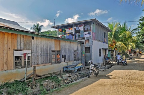 Side street with colourful laundry and locals in Labuan Bajo, Flores Island, Indonesia, Asia