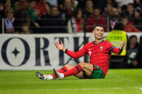 Football match, captain Cristiano RONALDO CR7 Portugal sits on the grass, has just been brought