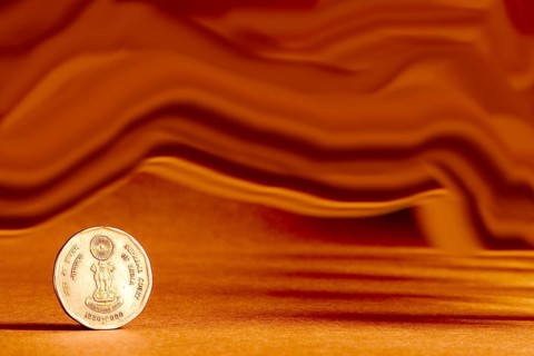 One single Indian currency two rupees coin and artistic background backside embossed Ashoka Pillar