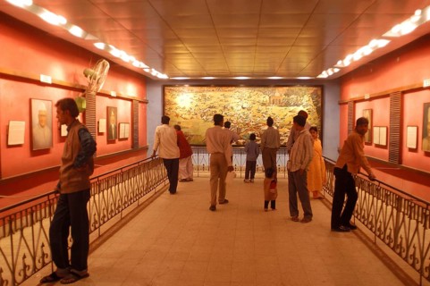 Visitors at the Jallianwala Bagh memorial in Amritsar in Punjab, India have a look at the huge