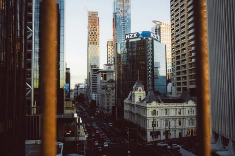 View of a busy street with the modern NZX skyscraper in the background, new zealand stock exchange,