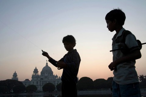Children flying kite near at Victoria memorial impressive reminder of British Raj built between