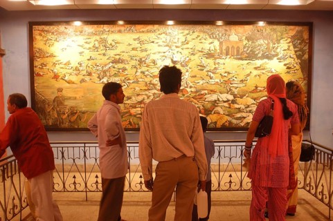 Visitors at the Jallianwala Bagh memorial in Amritsar in Punjab, India have a look at the huge
