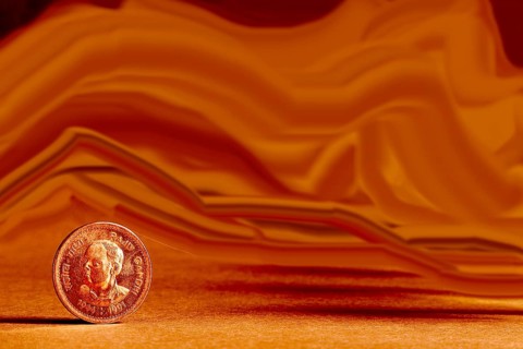 One single Indian currency one rupees coin and artistic background backside embossed Rajiv Gandhi
