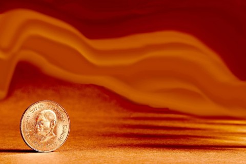 One single Indian currency one rupees coin and artistic background backside embossed Mahatma Gandhi