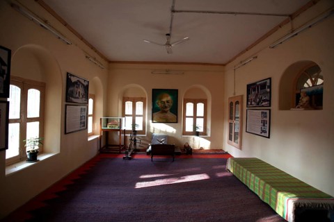 Mahatma Gandhi sitting place with large photograph and charkha at Satyagraha Ashram founded in