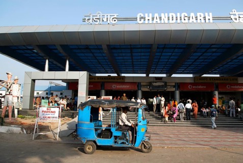 Blue auto rickshaw stand in front of Chandigarh railway station built in 1954, India Union