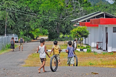 Children playing with tyres, Labuan Bajo, Flores Island, Indonesia, Asia