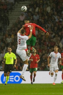 Football match, captain Cristiano RONALDO CR7 Portugal in red heading a ball three times as high as