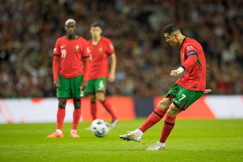 Football match, captain Cristiano RONALDO CR7 Portugal shoots the free kick with his right foot,