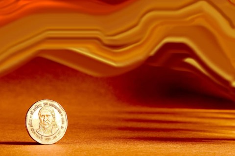One single Indian currency two rupees coin and artistic background backside embossed Sri Aurbindo