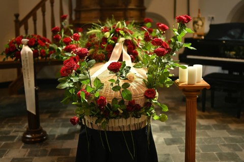 Red rose at the coffin, farewell to a dear deceased in the church in the Dutch province of Drenthe,