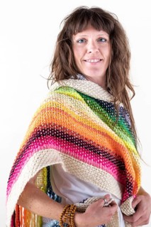 Smiling woman looking at camera, wearing a colored pashmina over a white background. Studio Shot