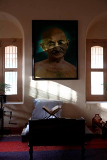 Mahatma Gandhi sitting place with his large photograph and his charkha at Satyagraha Ashram founded