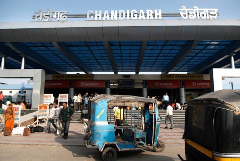 Blue auto rickshaw stand in front of Chandigarh railway station built in 1954, India Union