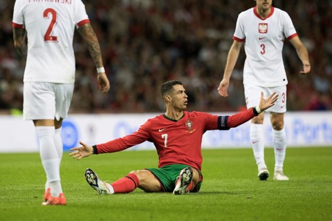 Football match, captain Cristiano RONALDO CR7 Portugal centre has just been fouled and is sitting