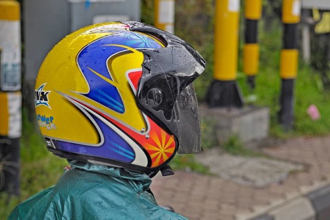 Brightly coloured motorbike shirt in the rain near Ubud, Bali, Indonesia, Asia