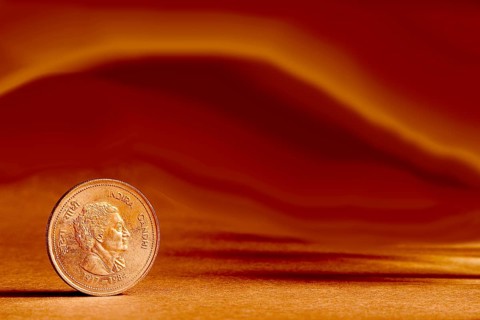One single Indian currency five rupees coin and artistic background backside embossed Indira Gandhi