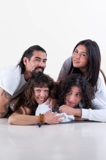Portrait of a group of yoga friends all looking at camera over white background. Studio shot. Copy