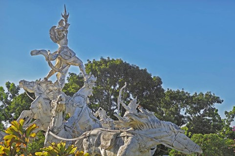 Balinese stone mythology figures on horse statues, Denpasar, Bali, Indonesia, Asia
