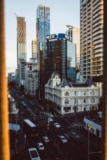 Urban scene with the NZX building and busy streets in the foreground, new zealand stock exchange,