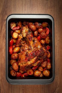 Pork knuckle, baked with vegetables, new potatoes, on a baking sheet, homemade, no people