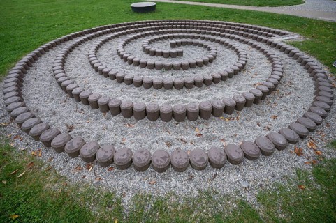 Built snail made of stones in front of the fortress walls of Dinkelsbühl, Bavaria, Germany, Europe