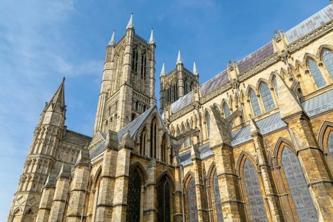Looking up at west towers of Lincoln cathedral church, city of Lincoln, Lincolnshire, England, UK